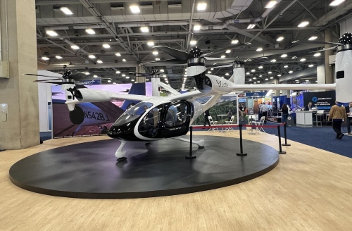 image of a modern flying vehicle on display at a trade show